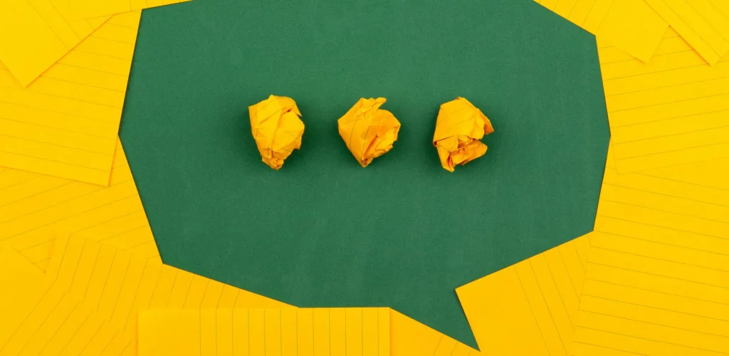 Image of three rolled yellow paper balls