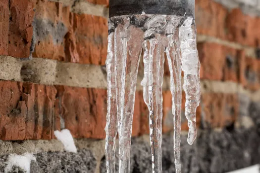 Natural icicles hanging in a pipe